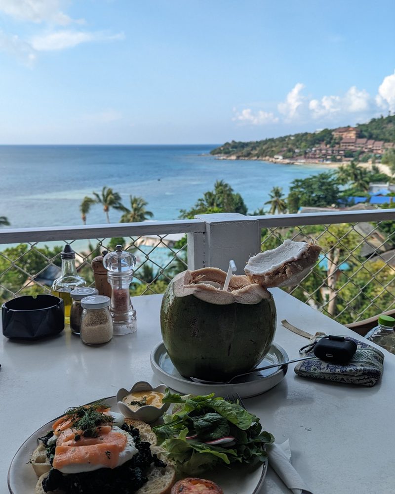 Breakfast with a fresh coconut above the sea